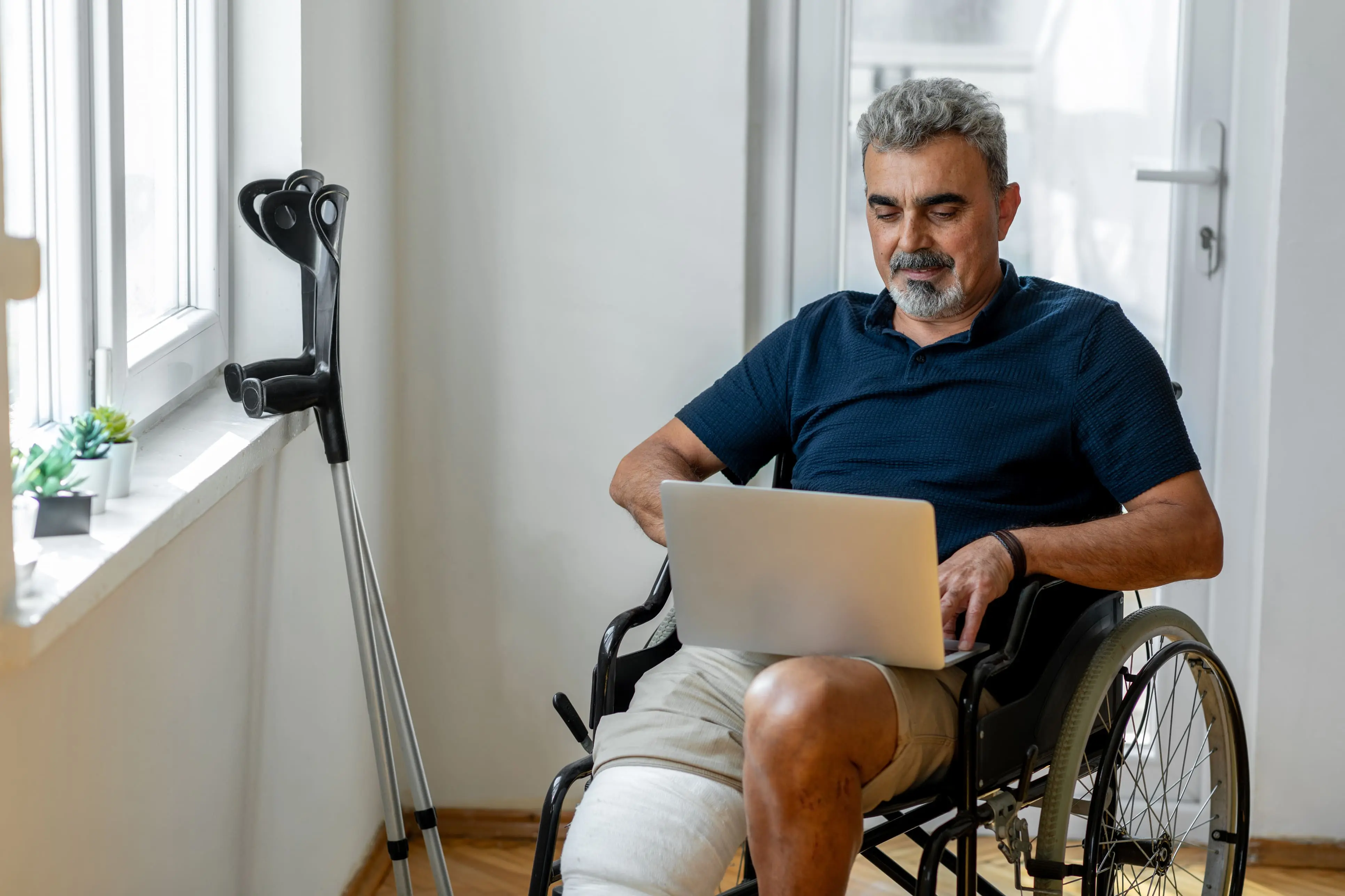 Man with broken leg in wheelchair